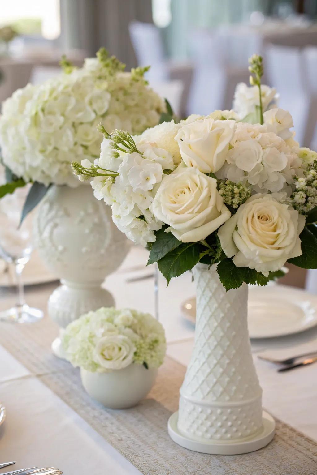 White flowers create a stunning centerpiece for an all-white dinner table.