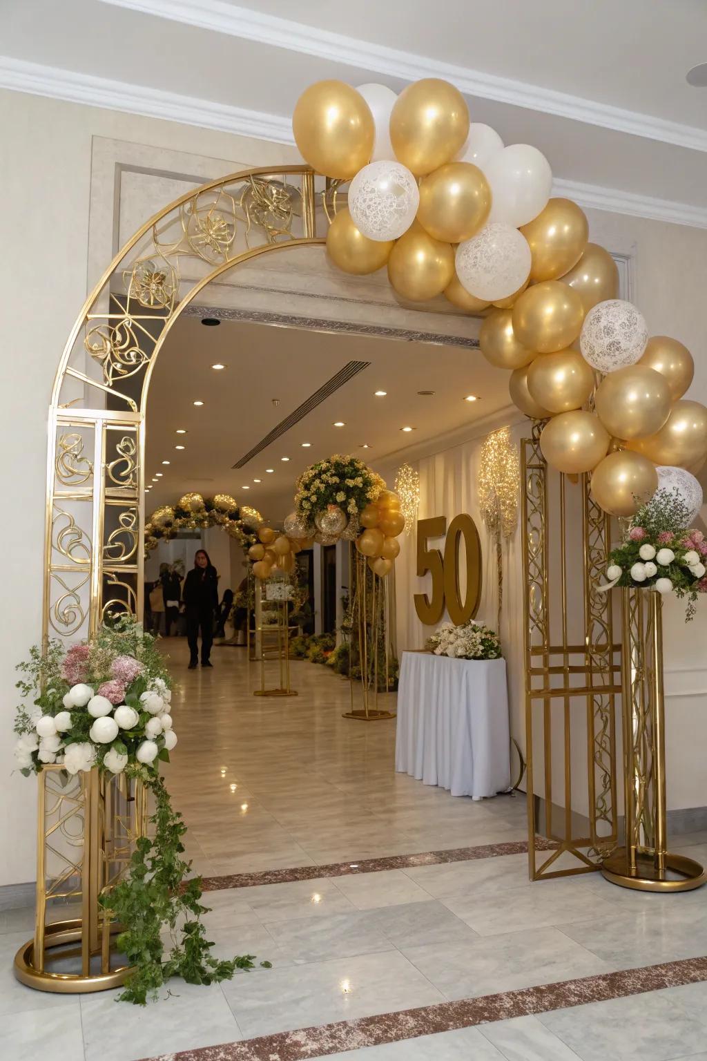 A grand gold balloon archway welcomes guests to the celebration.