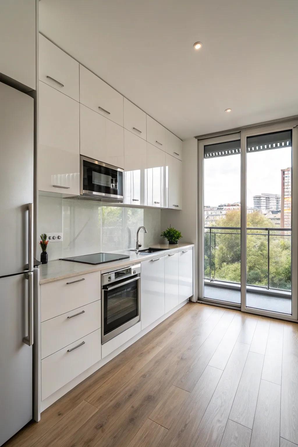 A minimalist one-wall kitchen with glossy cabinets and stainless steel appliances.