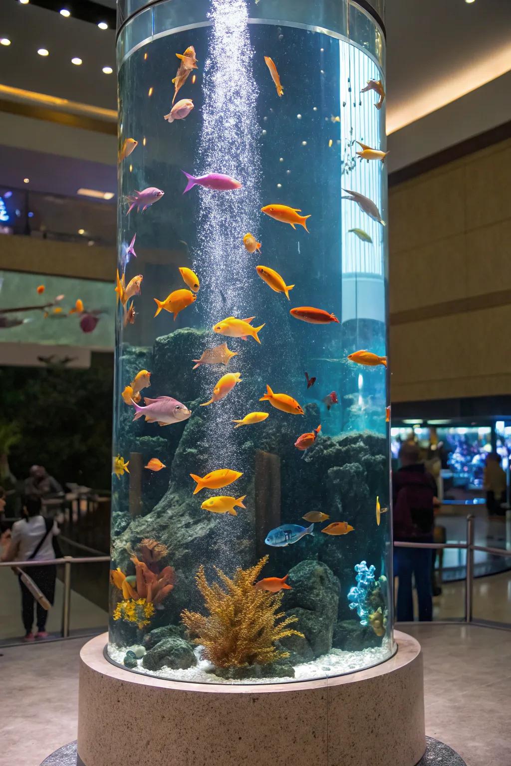 A colorful community of fish in a tall aquarium.