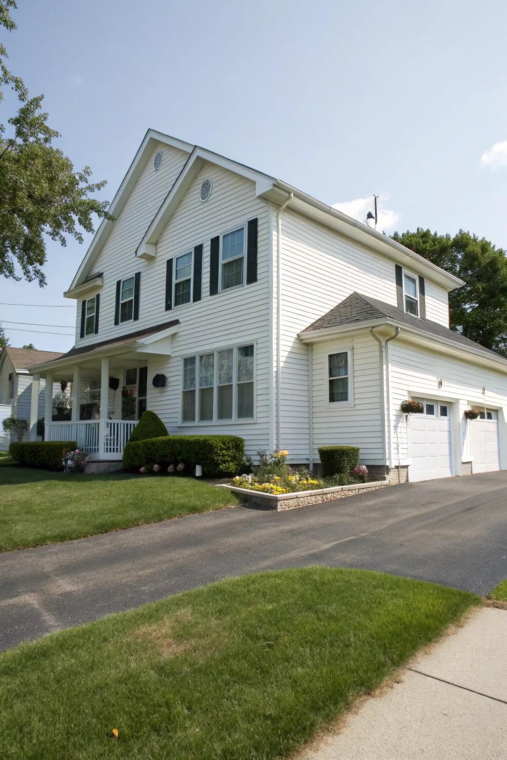 A grand two-story house featuring white vinyl siding.