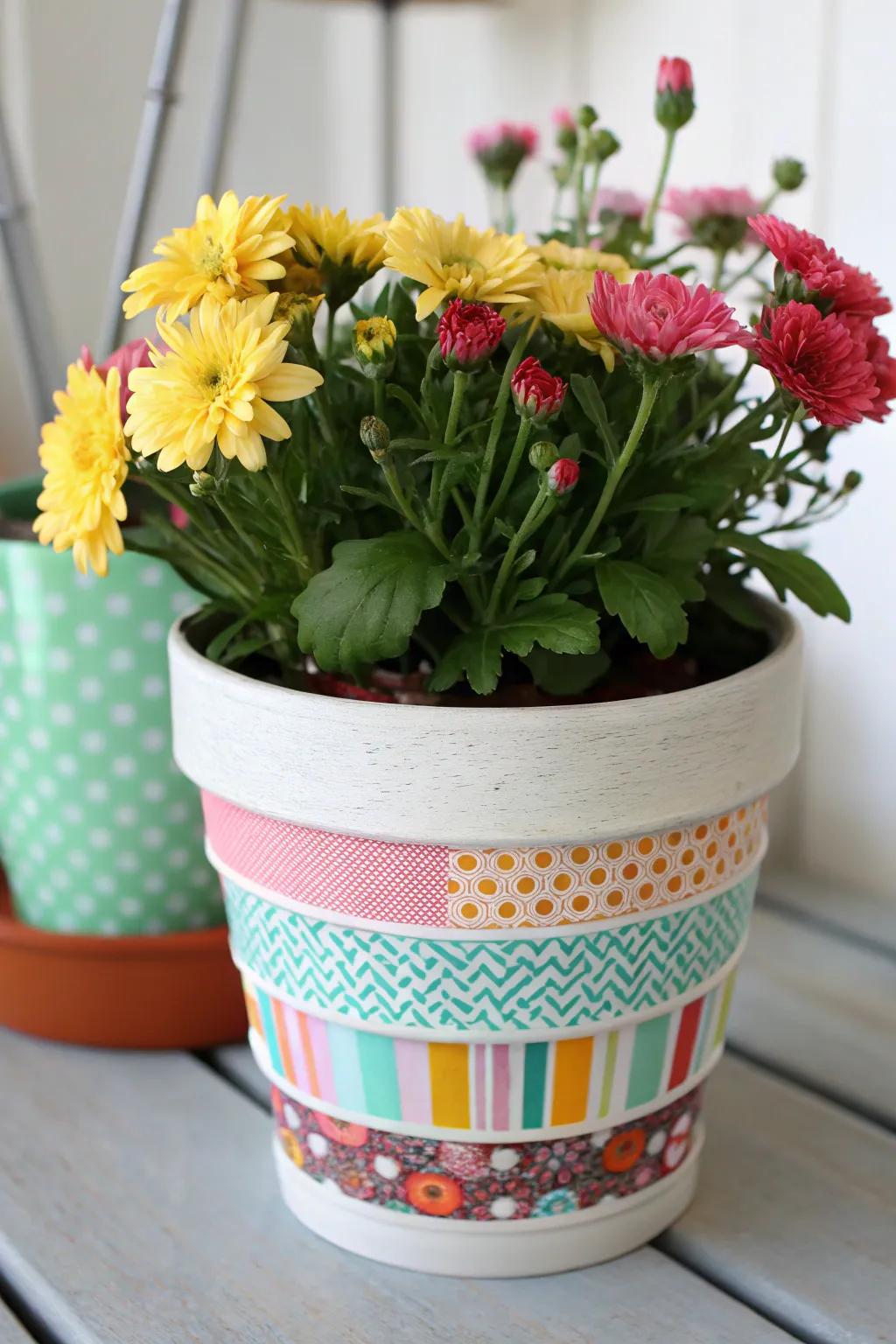 A flower pot enhanced with vibrant washi tape designs.