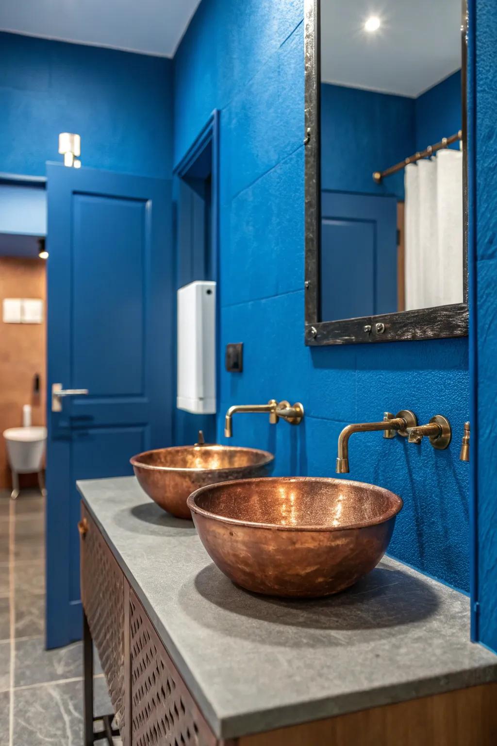 Bold blue walls provide a striking backdrop for the warm tones of this copper sink.