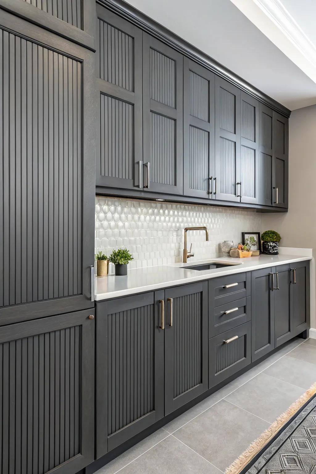 Vertical lines adding texture and height to the dark gray cabinets.