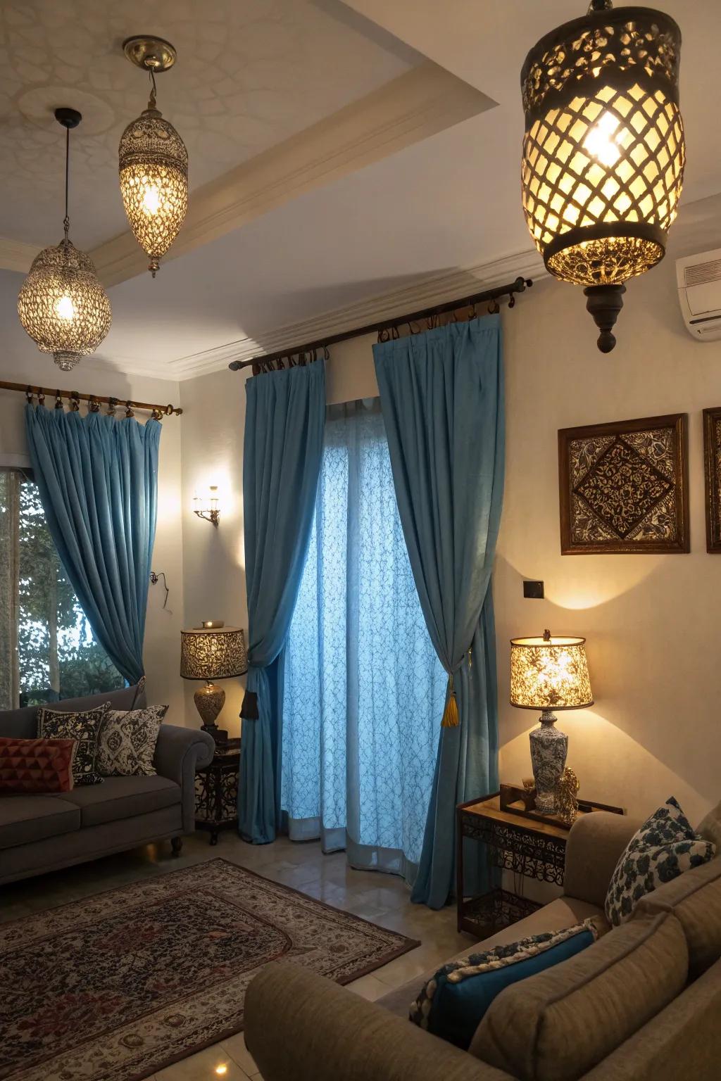 Different lighting fixtures interact with blue curtains to change the mood and elevate the room's ambiance.