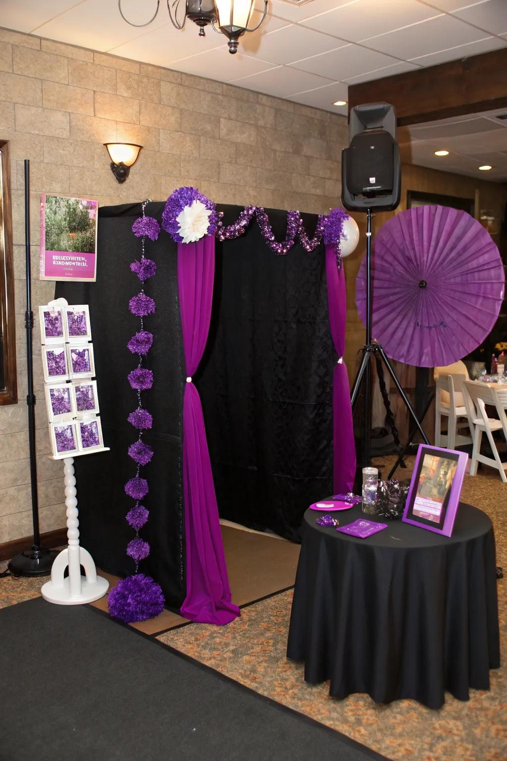 Creative photo booth with purple props and a black backdrop.