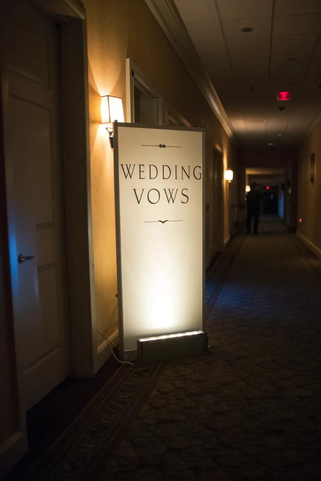 Glowing light box of vows adding warmth to a hallway.