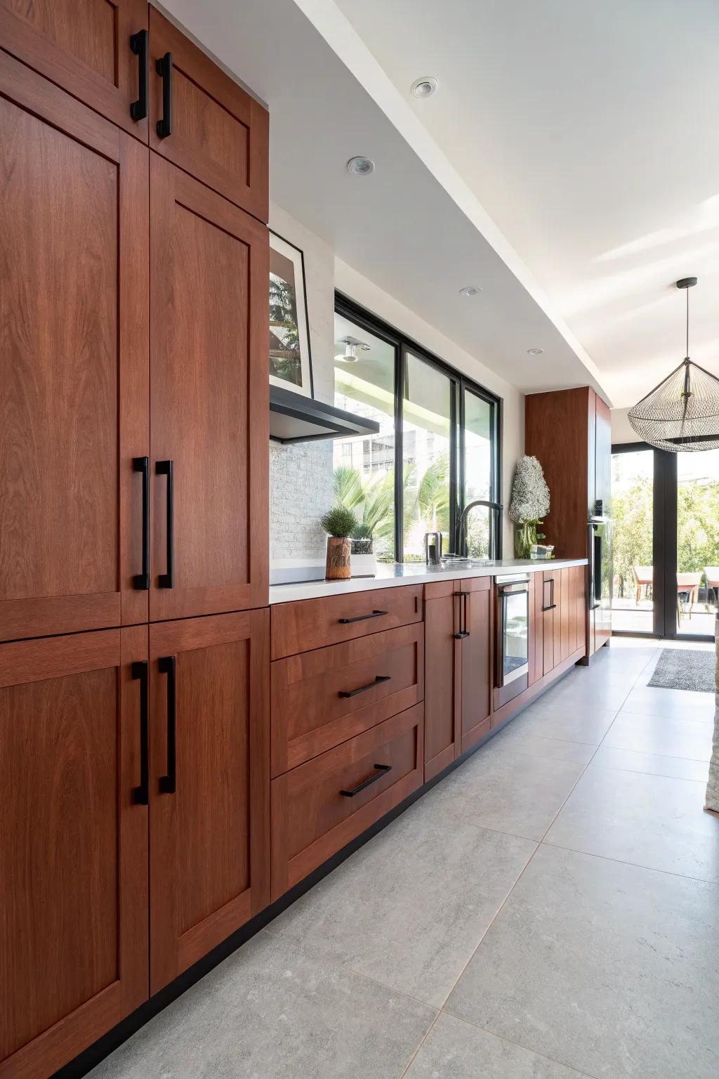 Bold black handles add a modern edge to cherry cabinets.