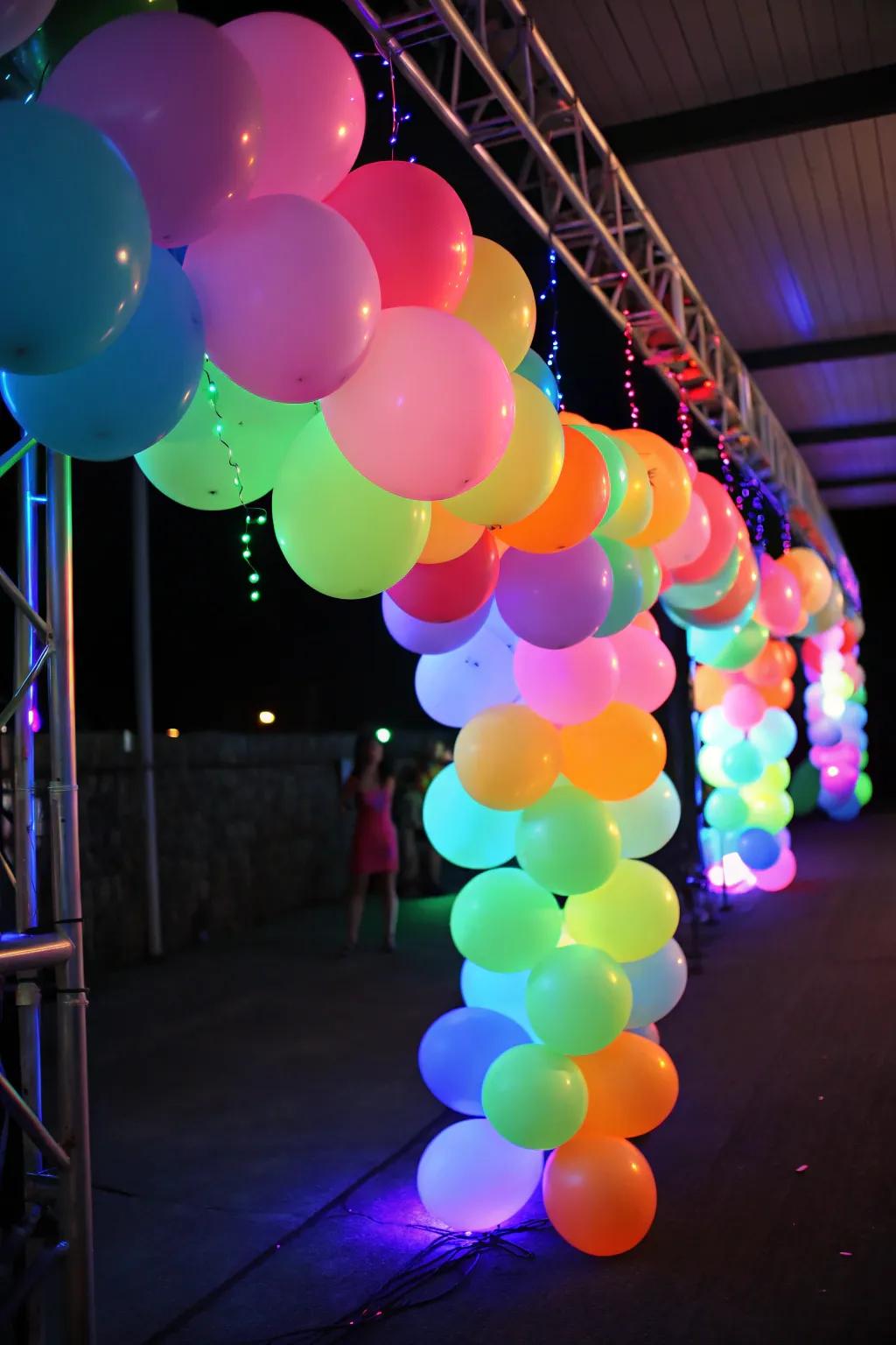 A vibrant neon balloon garland glowing under blacklight, perfect for a party backdrop.