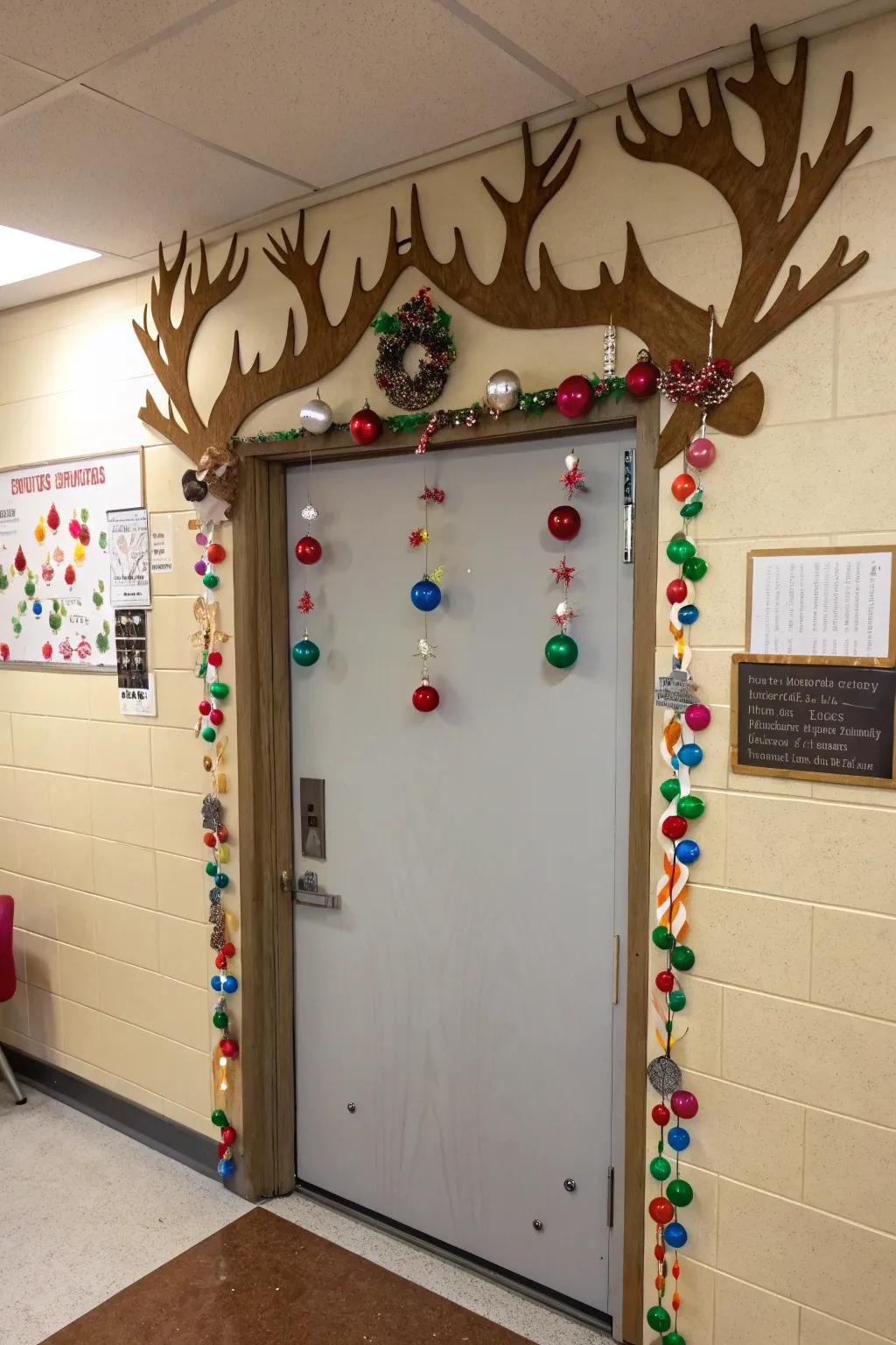 A classroom door with giant reindeer antlers, adorned with student-made ornaments.