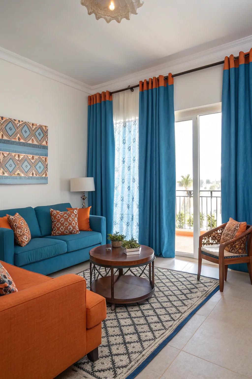 Bold orange accents bring a lively contrast to the serene blue curtains, energizing the room.