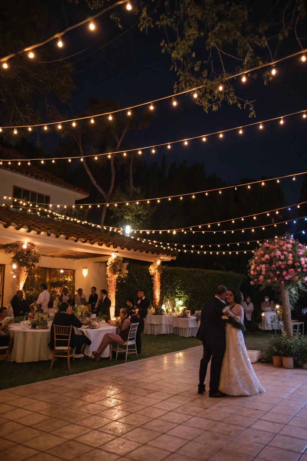 An evening wedding reception illuminated by the warm glow of string lights.