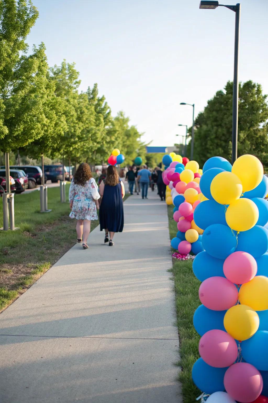 A festive outdoor balloon pathway guiding guests to the celebration.