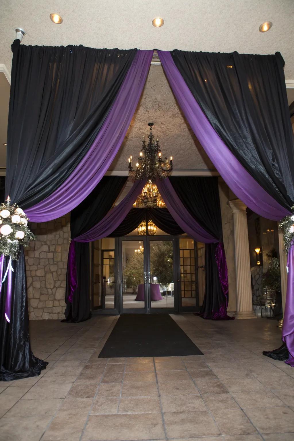 Sophisticated venue entrance decor with black and purple fabric.