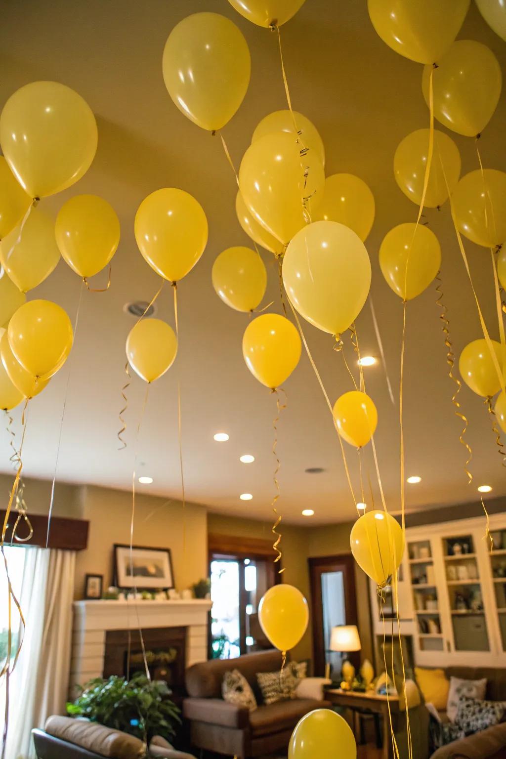 Whimsical ceiling filled with floating yellow balloons.