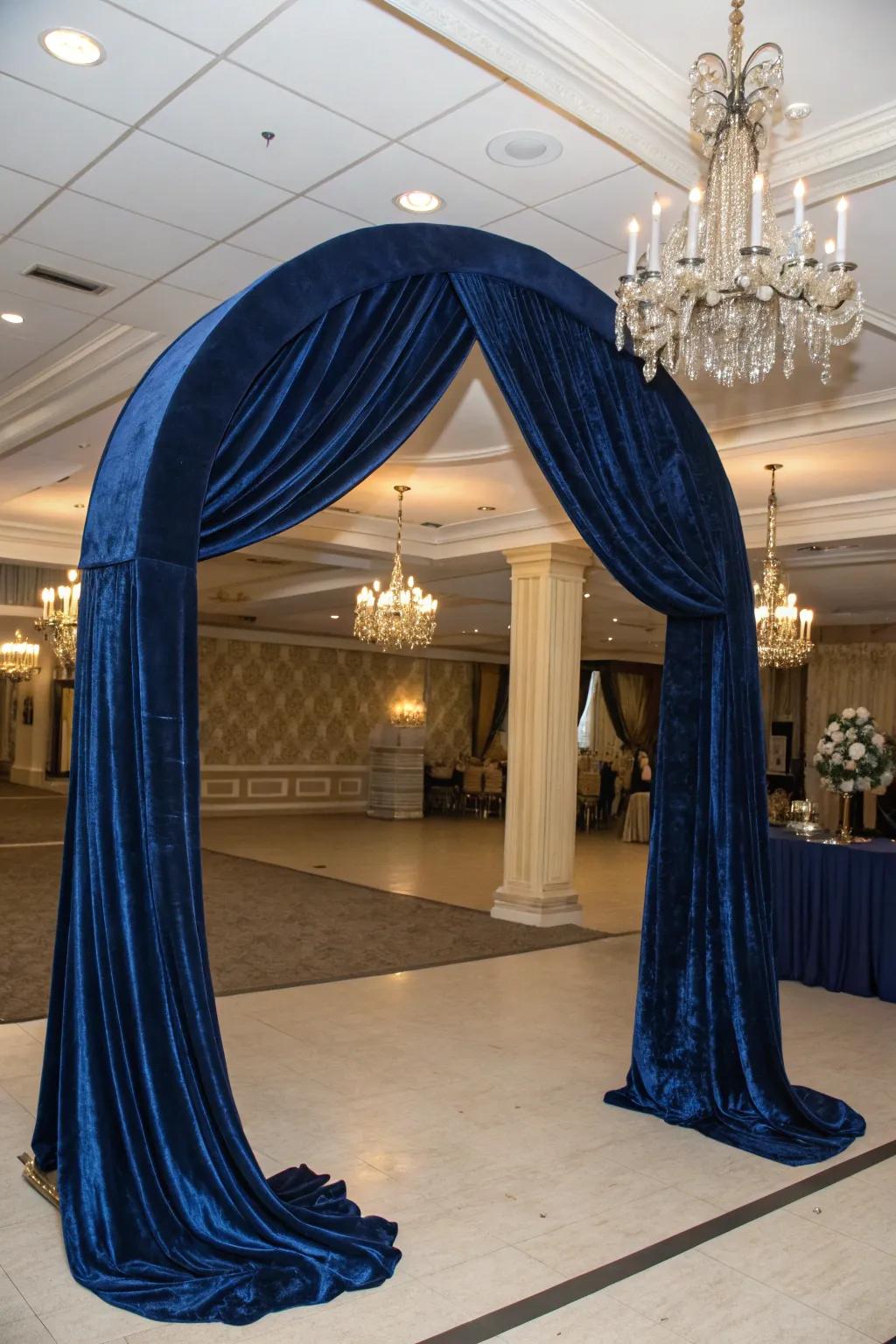 An elegant arch with luxurious velvet drapery for a dramatic effect.