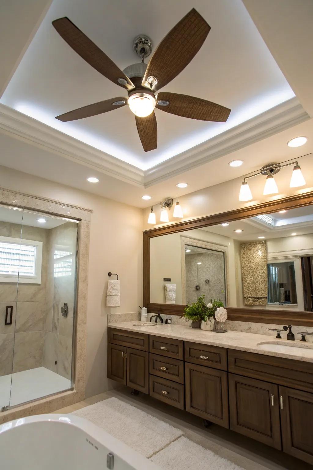 A sophisticated bathroom with a ceiling fan featuring recessed lighting.