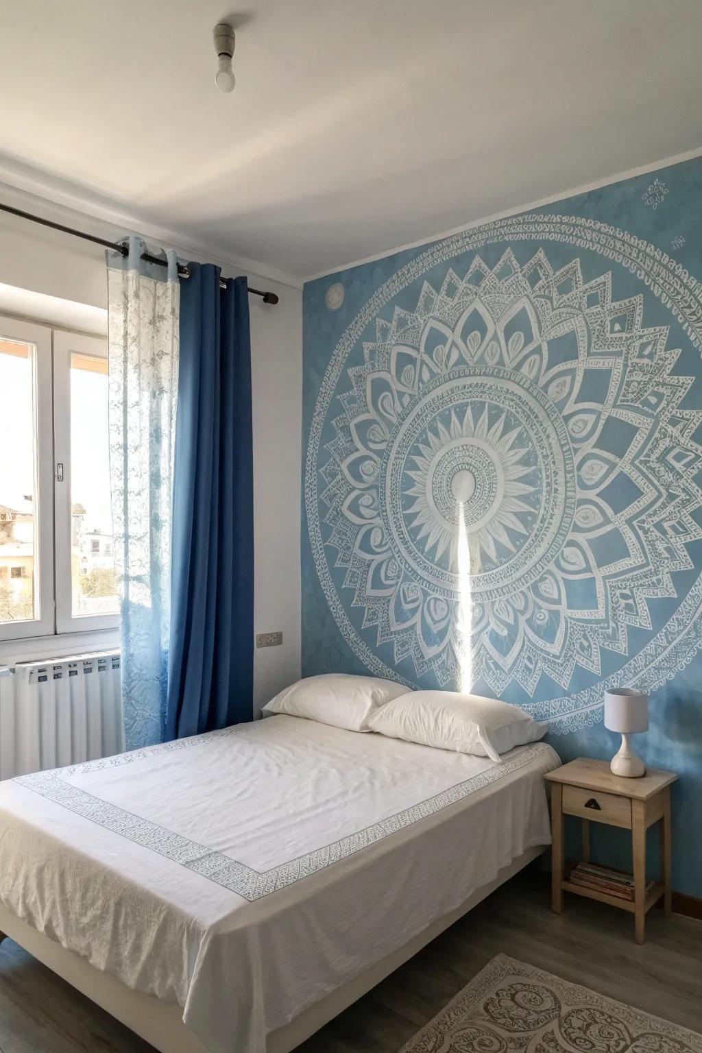 A subtle wall mural creates a focal point in a blue and white bedroom.