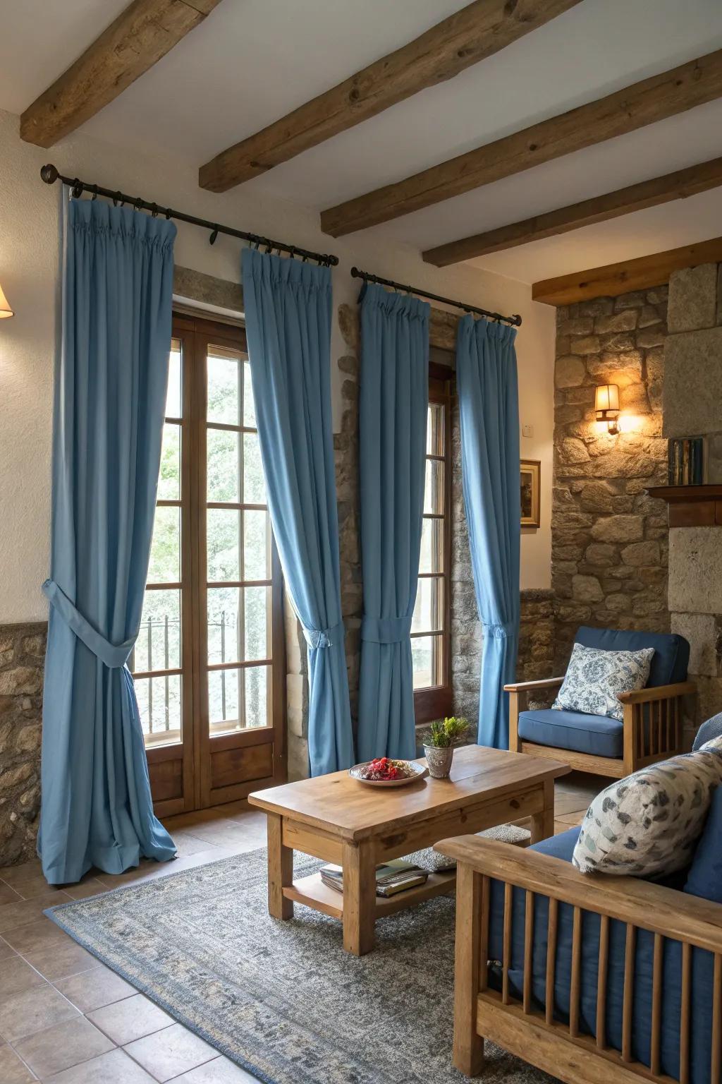 Natural elements like wood and stone complement blue curtains, adding warmth and texture to the room.